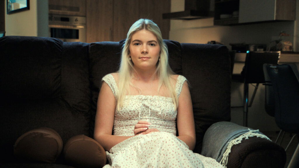 Charlie Sheen's daughter Lola Sheen, sitting in a couch in aka Charlie Sheen