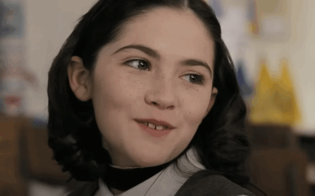 Esther, with dark hair, smiling in Orphan.