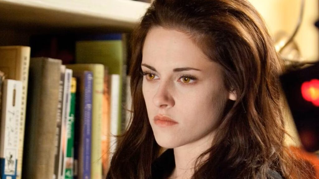 Bella (Kristen Stewart) stands among bookshelves after her vampire transformation in a still from Breaking Dawn Part 1.
