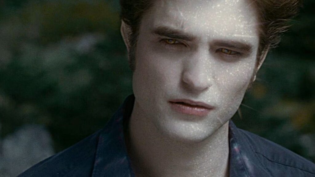 A close-up of Edward's face (Robert Pattinson) with his skin sparkling like diamonds in sunlight, revealing his vampire nature.