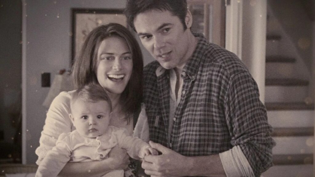 A happy family moment showing Renée (Sarah Clarke) holding baby Bella, and Charlie (Billy Burke) standing close to them in their home in a throwback picture.