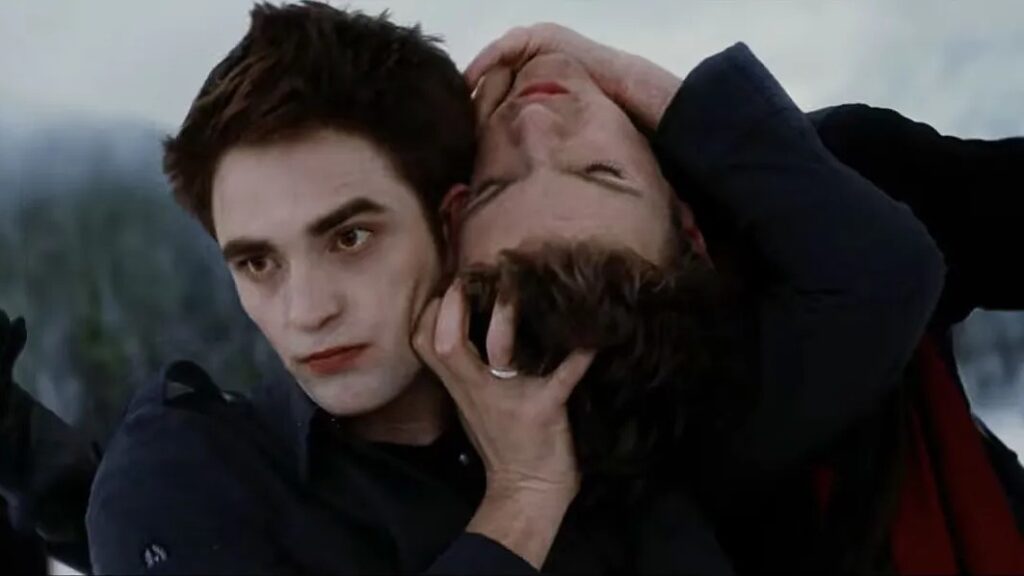 Edward Cullen (Robert Pattinson) holds the head of a vampire from the opposing team (about to rip it off) during the intense battle sequence in Breaking Dawn Part 2.