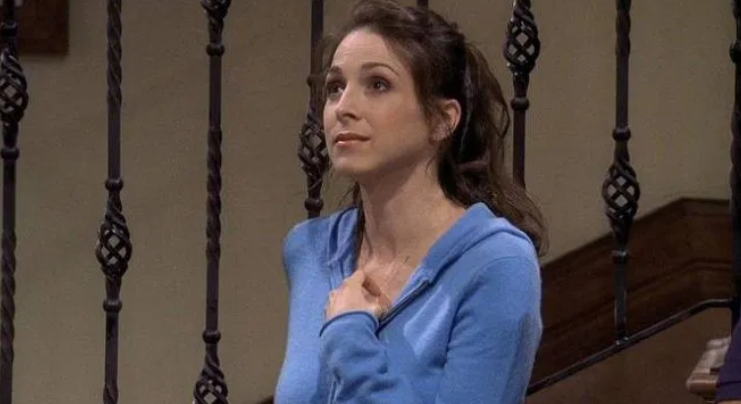 Judith is looking up at someone with a smile on her face.