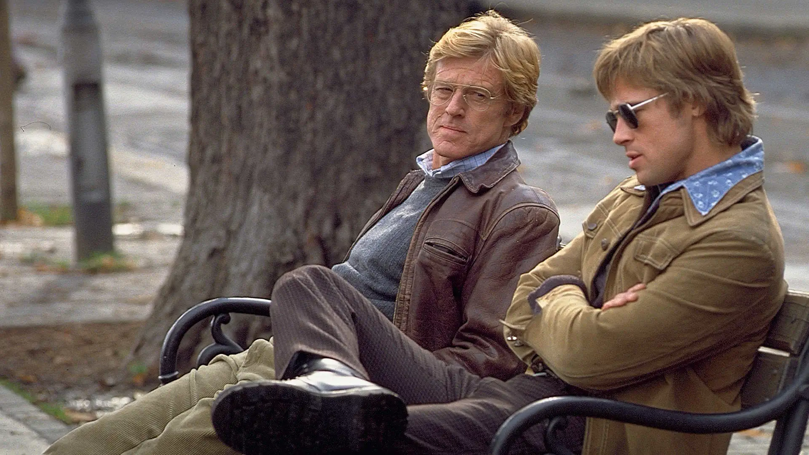 Brad Pitt and Robert Redford sitting on a park bench 