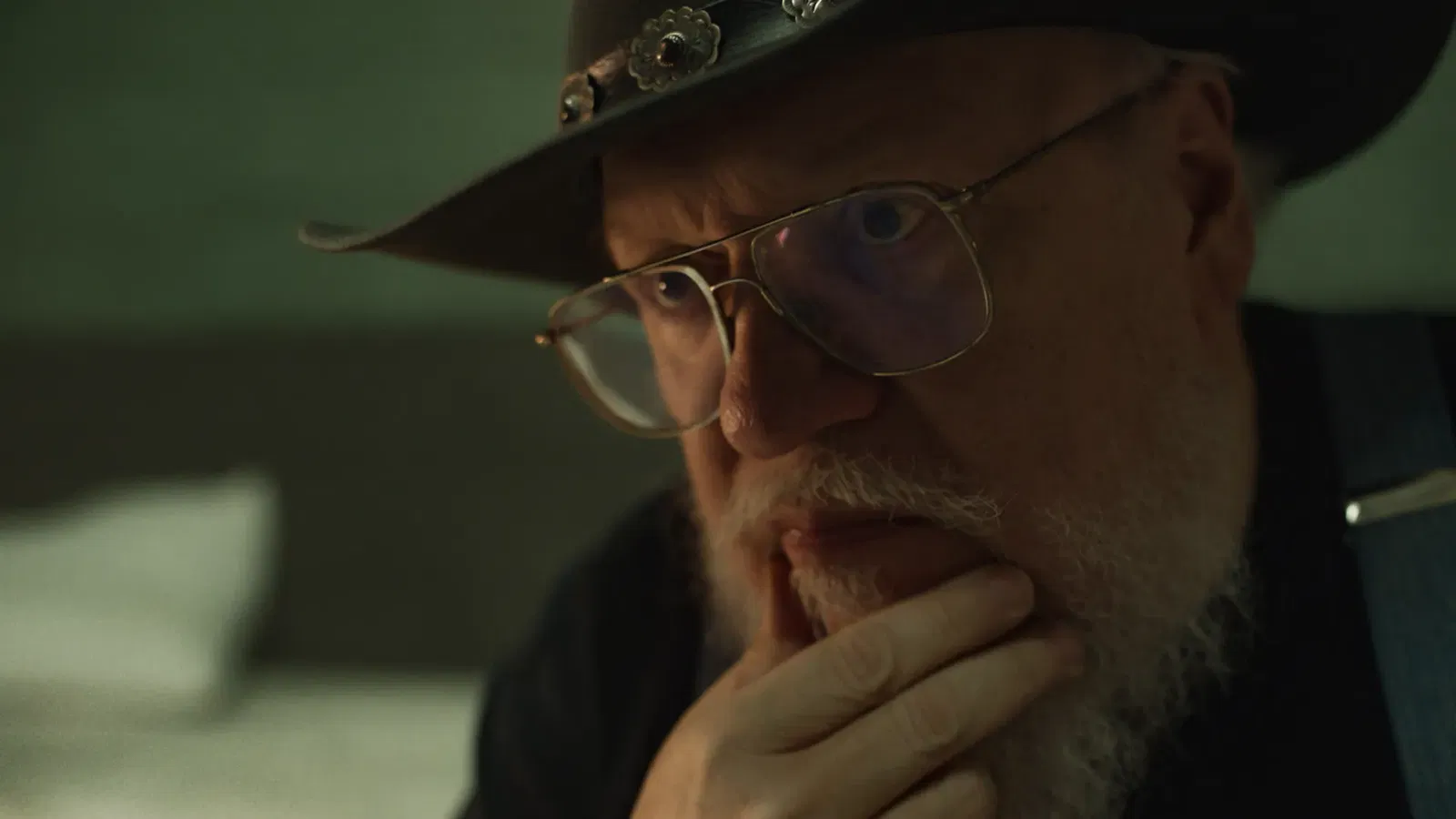 George R.R. Martin looking with his hand on his chin
