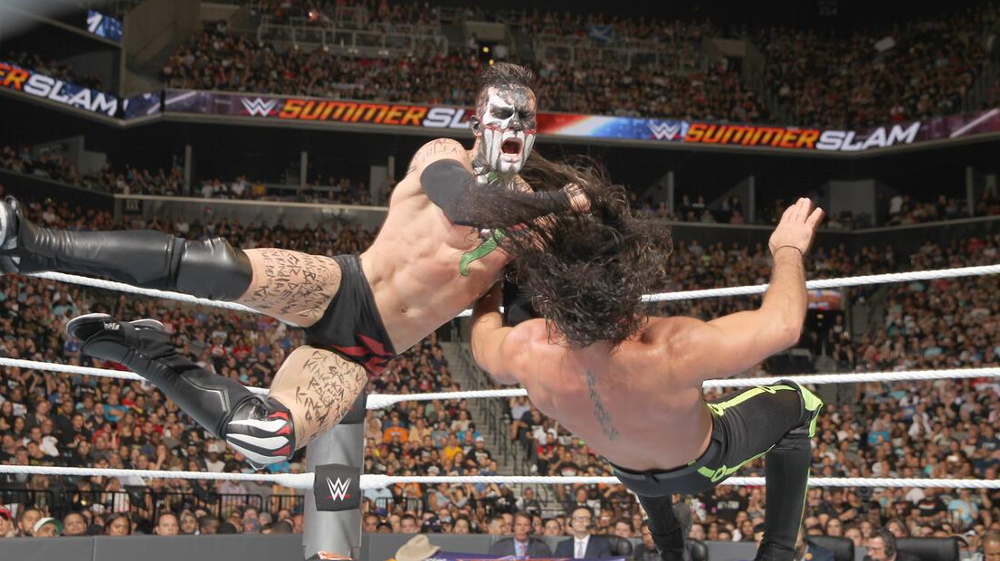 Finn Bálor delivering a Swing Blade to Seth Rollins