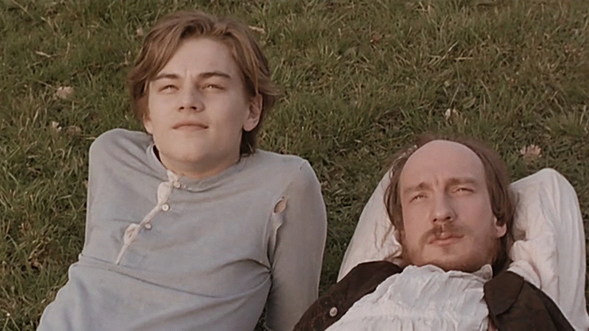 Leonardo DiCaprio with David Thewlis lying on the ground looking at the sky