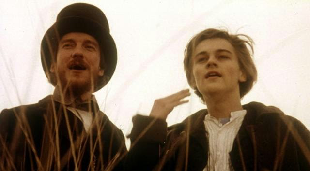 Leonardo DiCaprio with David Thewlis looking at something and smiling 