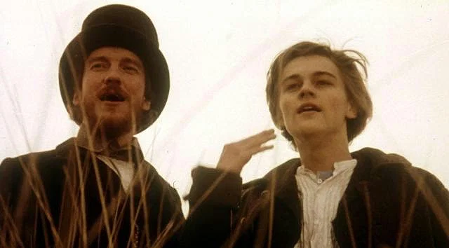 Leonardo DiCaprio with David Thewlis looking at something and smiling