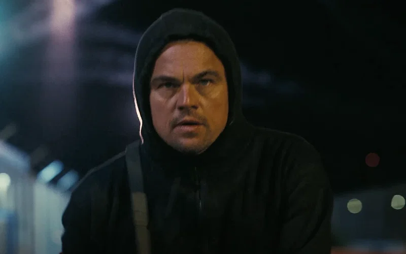 Leonardo DiCaprio wearing a black hoodie in One Battle After Another.