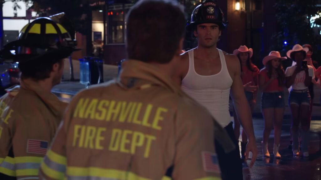 members of the Nashville Fire Department, identifiable by the text "NASHVILLE FIRE DEPT" on the back of a firefighter's uniform. 