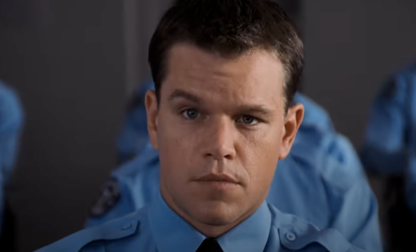 Matt Damon wearing a blue uniform  in The Departed. 