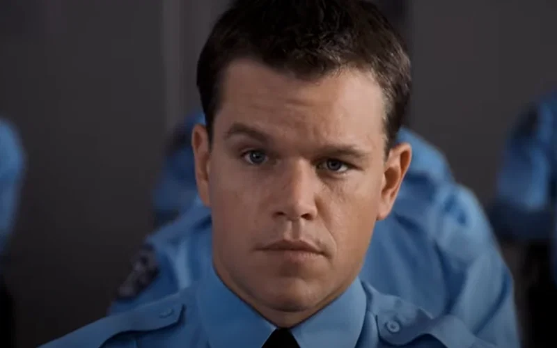 Matt Damon wearing a blue uniform in The Departed.