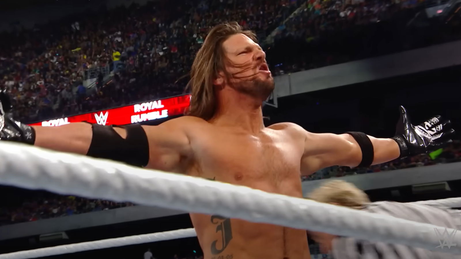 AJ Styles posing during a match with John Cena