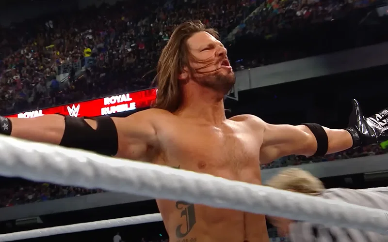 AJ Styles posing during a match with John Cena