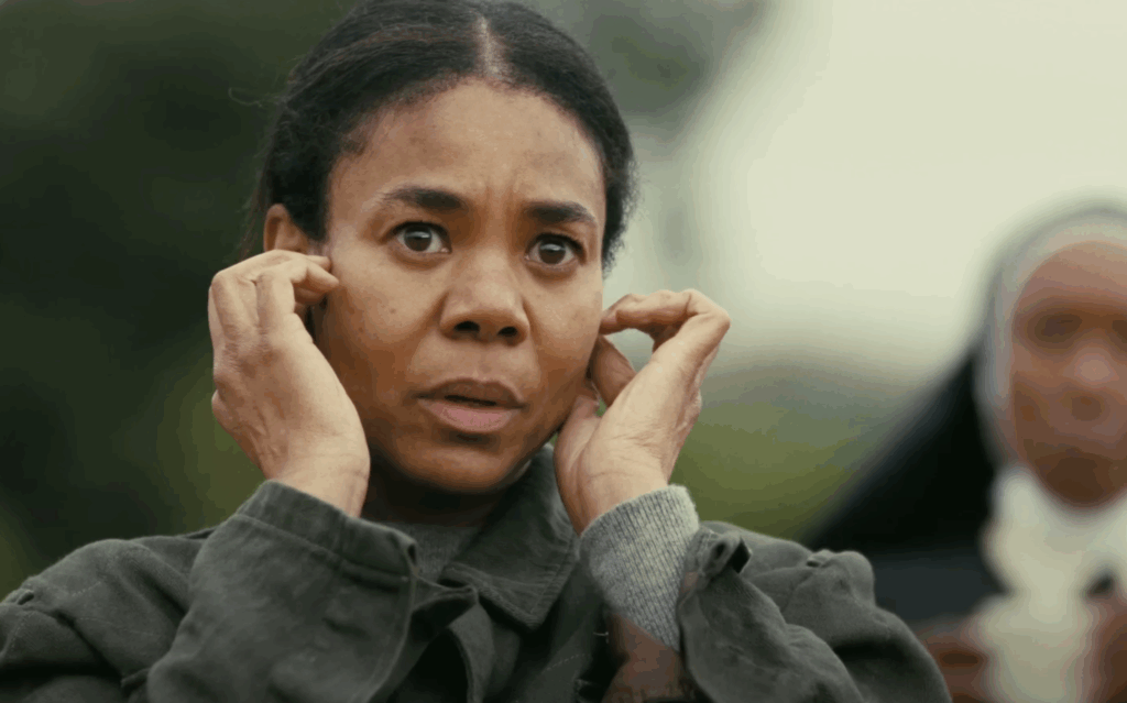Regina Hall covering her ears in One Battle After Another. 