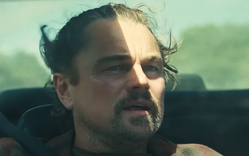 Leonardo DiCaprio's Bob sitting in a convertible car in One Battle After Another.