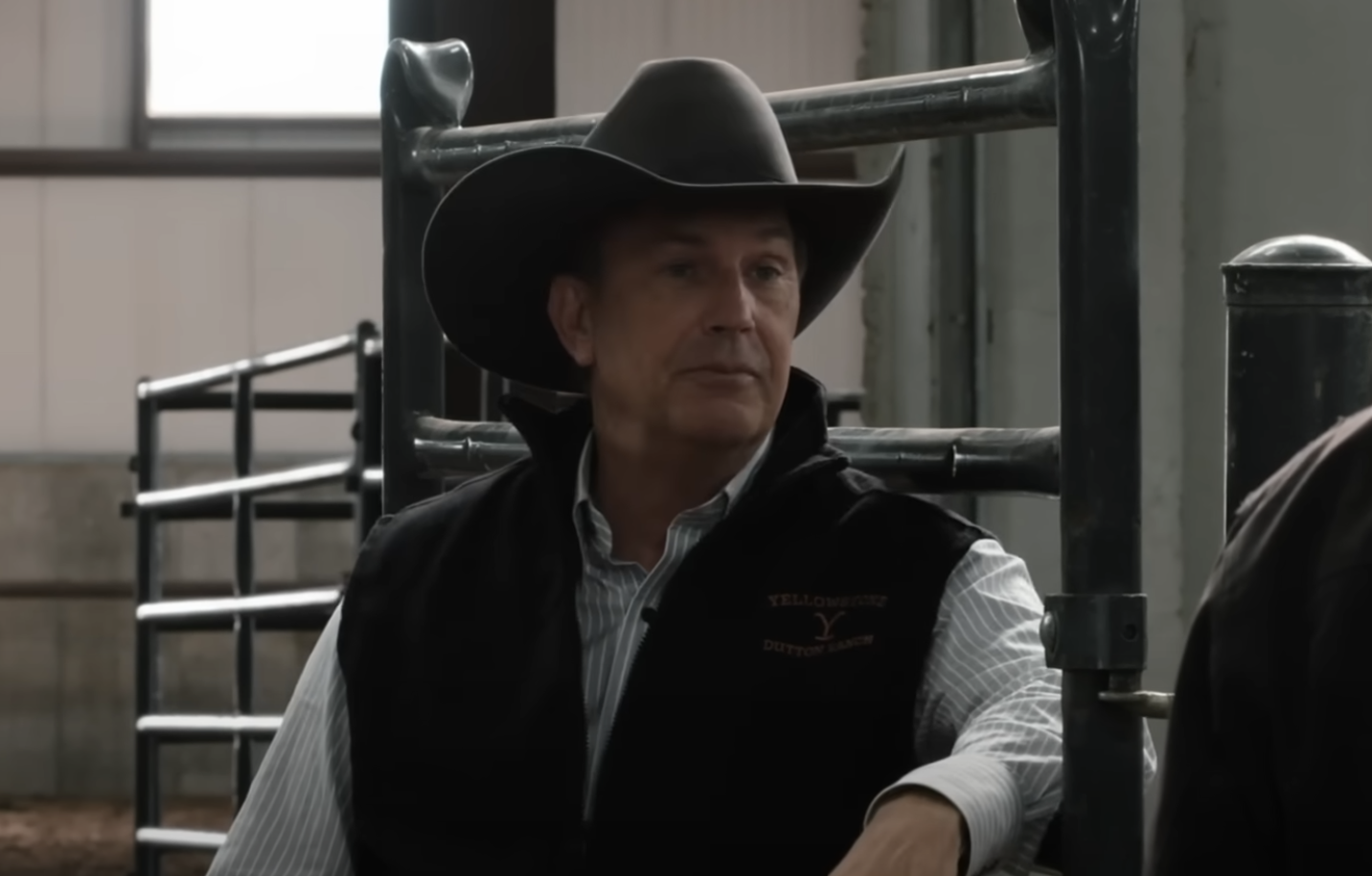 Kevin Costner in a black cowboy hat and vest in Yellowstone. 