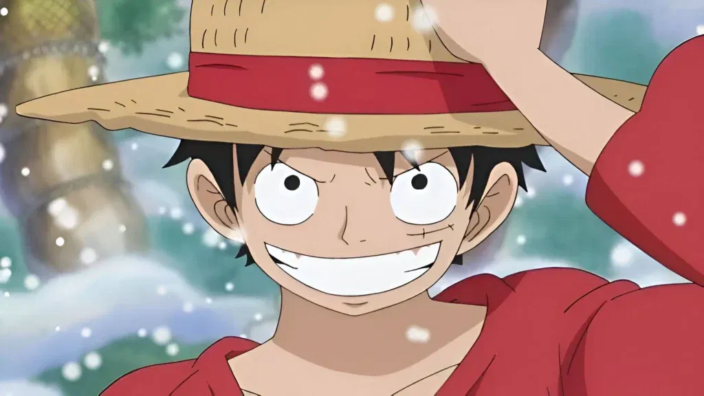 Trong anime One Piece, Luffy cầm chiếc mũ rơm và mỉm cười rạng rỡ.