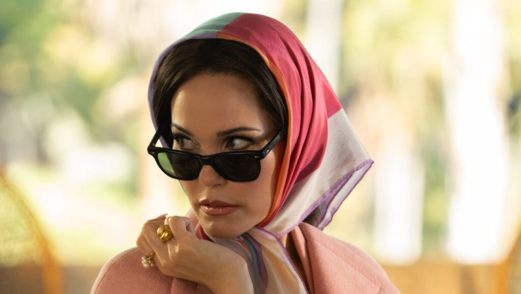 A woman wears sunglasses in palm royale