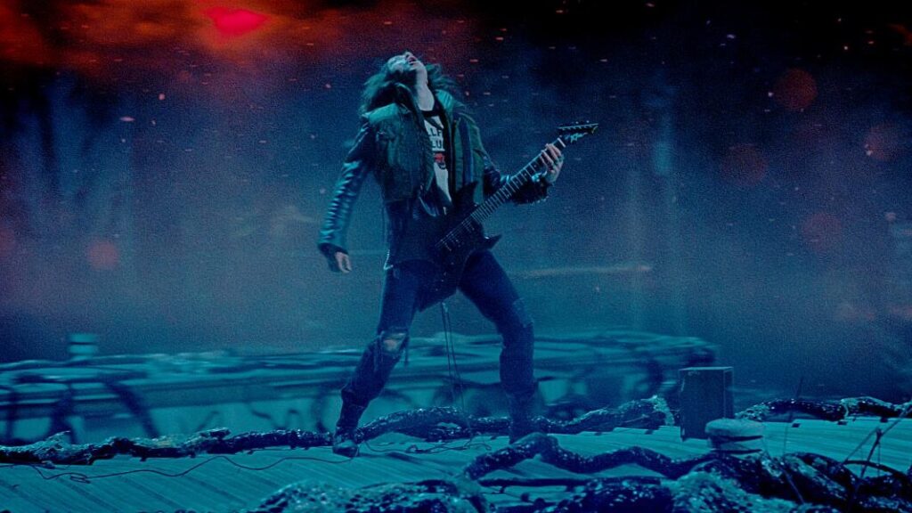 Eddie Munson performing epic guitar solo on top of trailer in the Upside Down during Master of Puppets scene