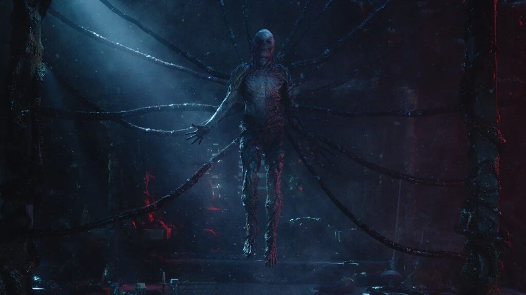 Vecna suspended in the Upside Down surrounded by dark vines and atmospheric blue lighting in Stranger Things