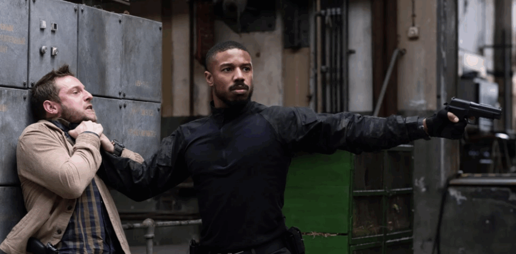 Every Taylor Sheridan Movie, Ranked Worst to Best 1 Michael B. Jordan is holding a gun and restraining another man.