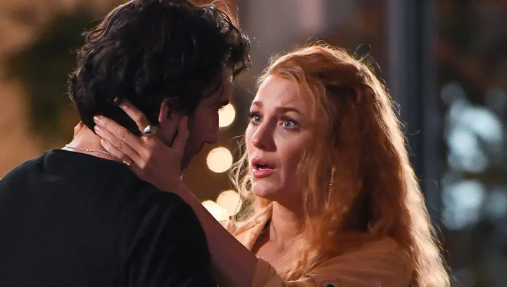 Blake Lively and Justin Baldoni are sharing a very close and intimate moment, with Lively holding Baldoni's face gently.