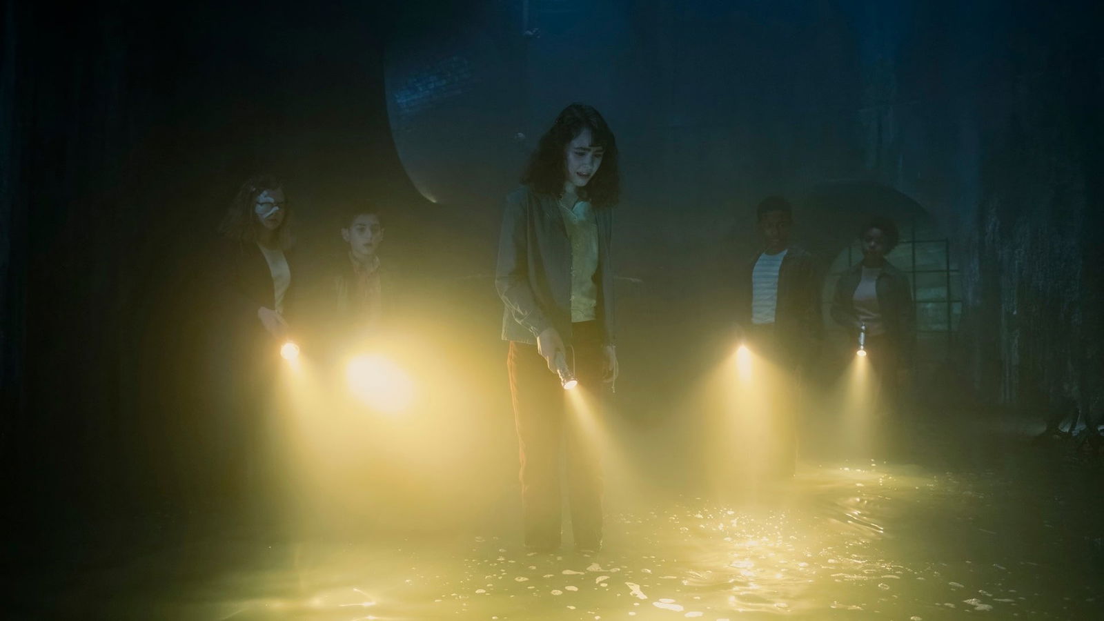 Young Losers Club exploring Derry sewers with flashlights in It Welcome to Derry Neibolt Street episode