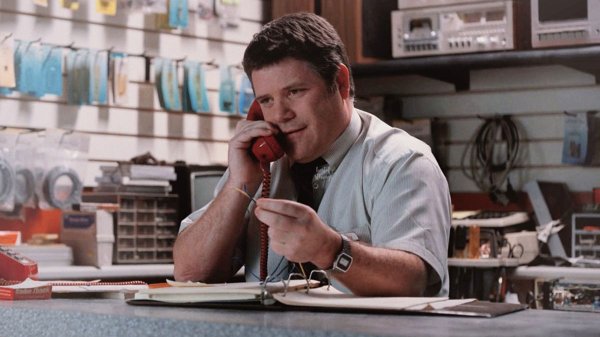 Bob Newby (Sean Astin) working at RadioShack in Stranger Things Season 2 and talking on a phone