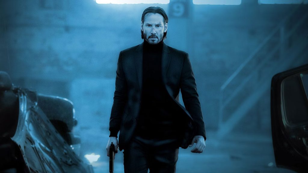 Keanu Reeves walking with a lowered gun in John Wick: Chapter 2