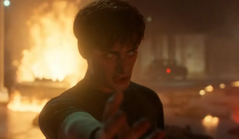 Will, in the show Stranger Things, has glowing white eyes while reaching out his hand.