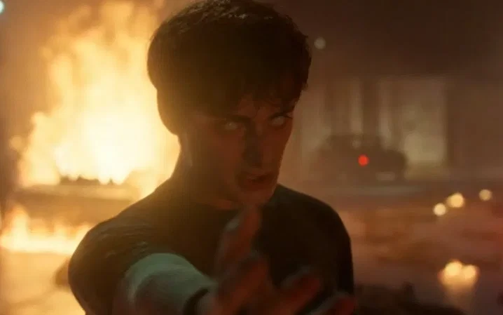 Will, in the show Stranger Things, has glowing white eyes while reaching out his hand.