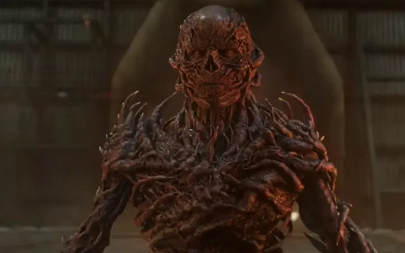 The terrifying main villain, Vecna, in his full monstrous form, made of vines and flesh from the Upside Down.