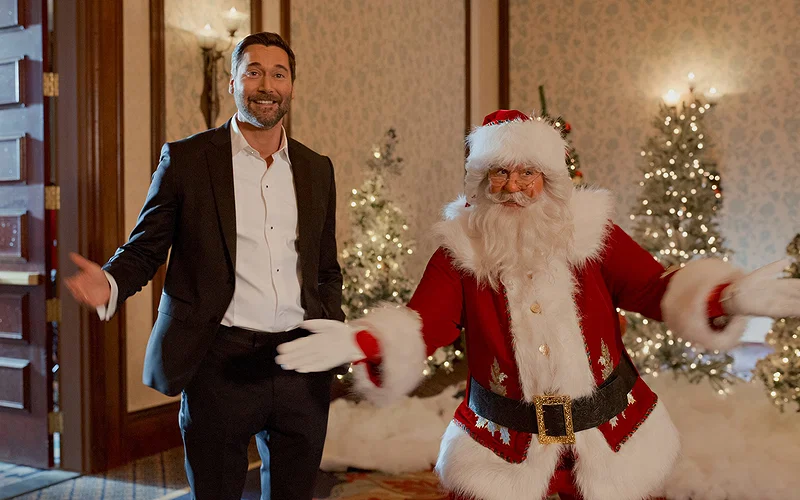 A still from My Secret Santa featuring Matthew and Santa Claus in a hotel lobby