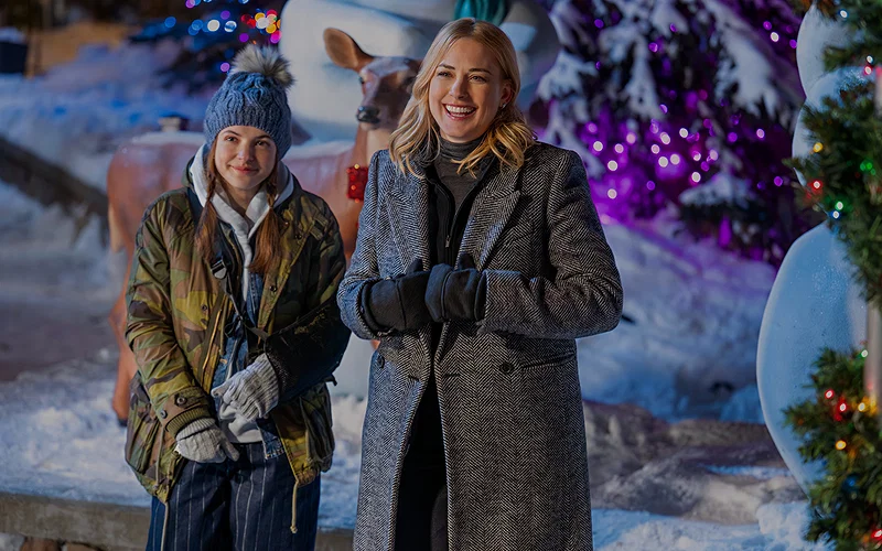 A still from My Secret Santa featuring Zoey and Taylor standing outside in winter clothes