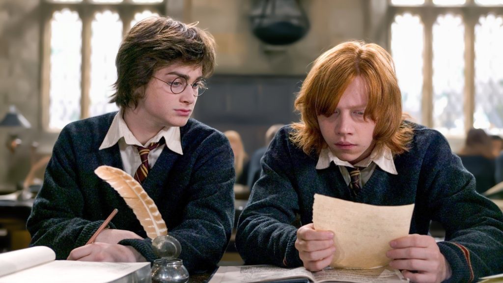 daniel radcliffe as harry potter and rupert grint as ron weasley in harry potter reading