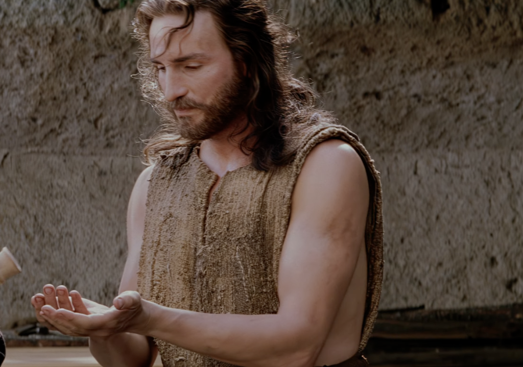 Jesus holding out his hands to wash