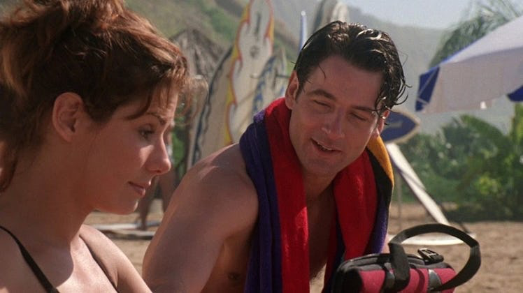 31 Years Ago, Sandra Bullock Set an Unbeatable Record to Promote Her Underrated ‘90s Thriller 37 Sandra bullock sitting with a man on the beach