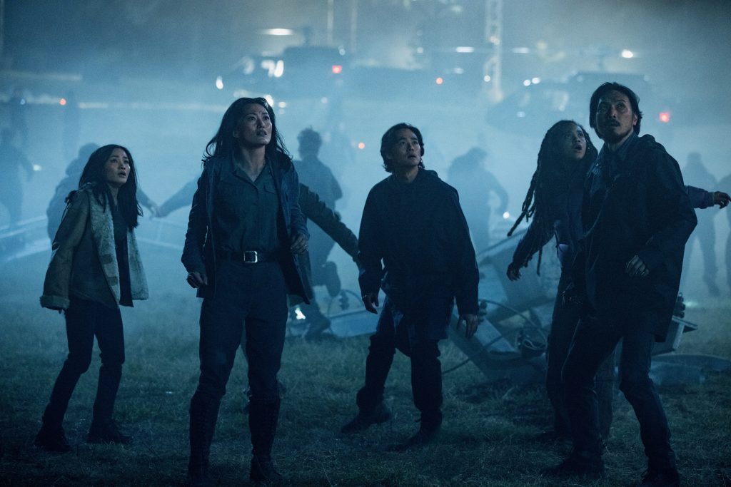 A still from Monarch: Legacy of Monsters Season 2 featuring the Randa family and May staring up at something