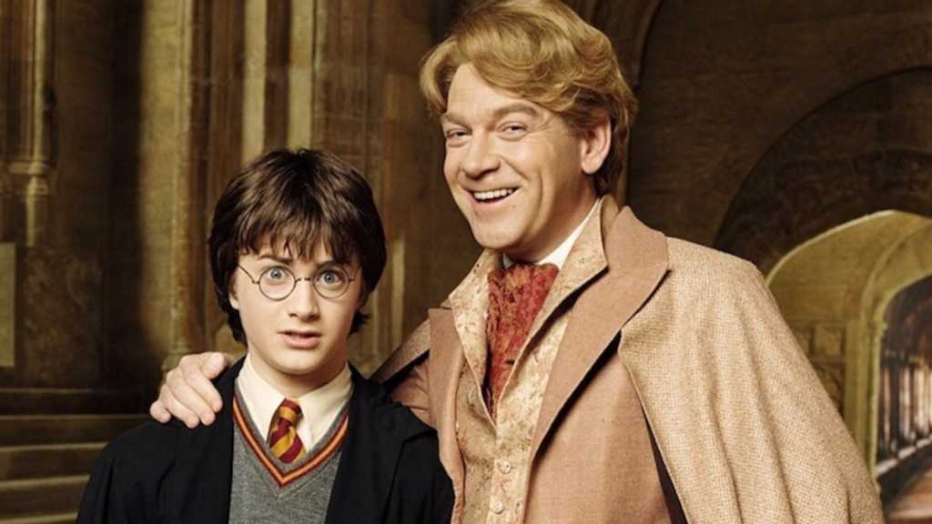 Gilderoy lockhart smiling and posing with harry.