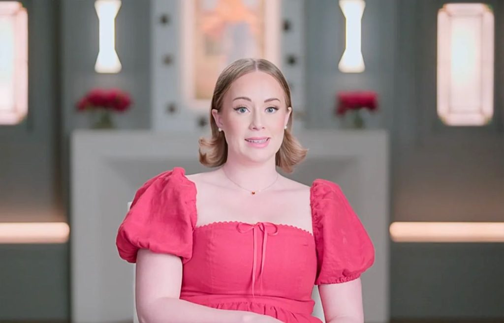 The Secret Lives of Mormon Wives Season 4: Who Is the Richest Among the Cast? Net Worth Breakdown 8 Whitney Leavitt in red outfit in confessional for The Secret Lives of Mormon Wives