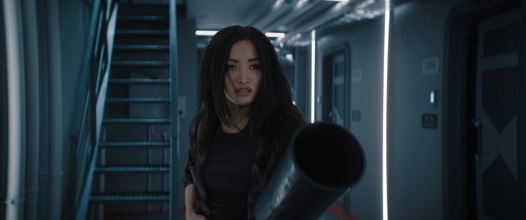 A still from Monarch: Legacy of Monsters Season 2 featuring Cate brandishing a fire extinguisher