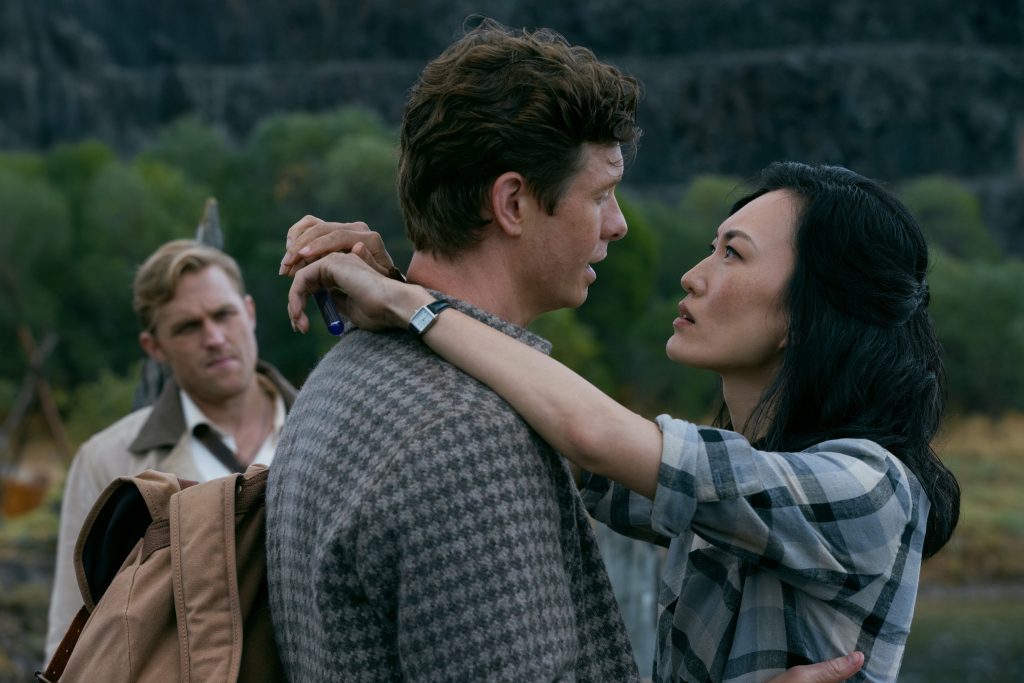 A still from Monarch: Legacy of Monsters Season 2 featuring Bill and Keiko embracing while Lee looks on from the sidelines
