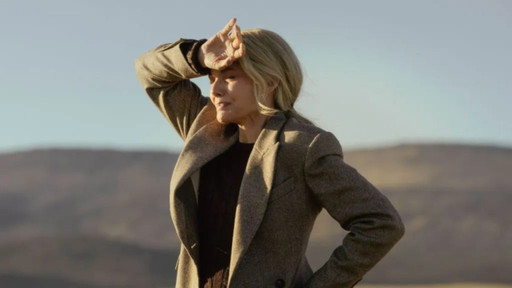 Michelle Pfeiffer shielding her eyes from the sun while standing outdoors against a Montana desert landscape in The Madison on Paramount+