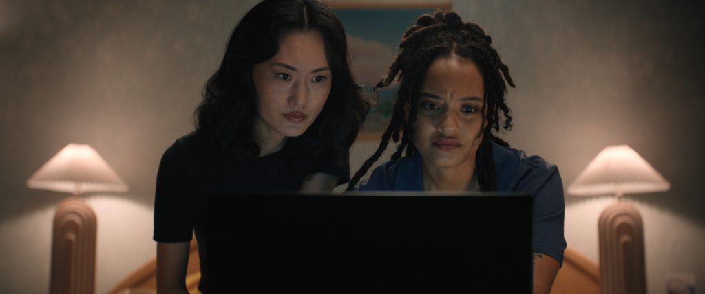 A still from Monarch: Legacy of Monsters Season 2 featuring Keiko and May looking at a computer screen