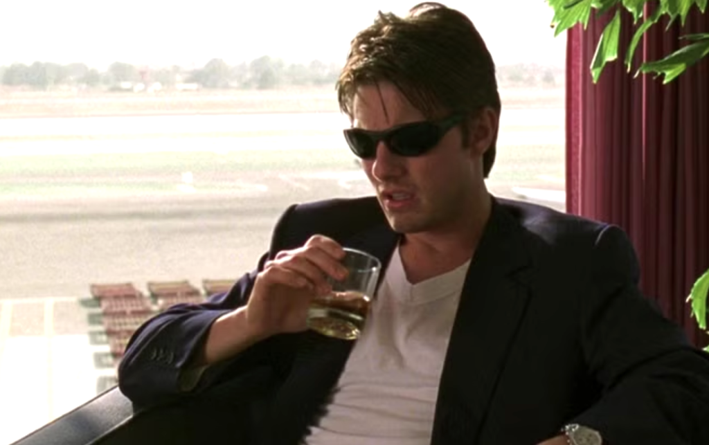 Tom Cruise wearing black sunglasses and blazer in Jerry Maguire 
