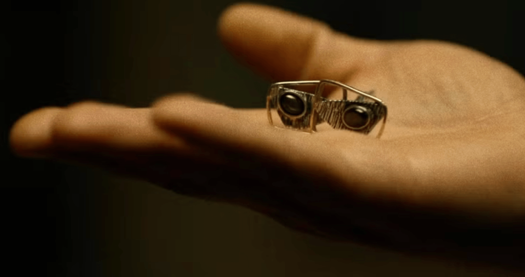 Wilson Fisk holding cufflinks 