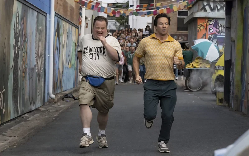 Balls Up Review — Wahlberg and Hauser Can’t Save Peter Farrelly’s Limp Comedy Lacking Cojones 1 Elijah Paul Walter Hauser and Brad Mark Wahlberg in BALLS UP Photo Credit Ben Rothstein Prime Video %C2%A9 Amazon Content Services LLC copy 1280x720 1 scaled