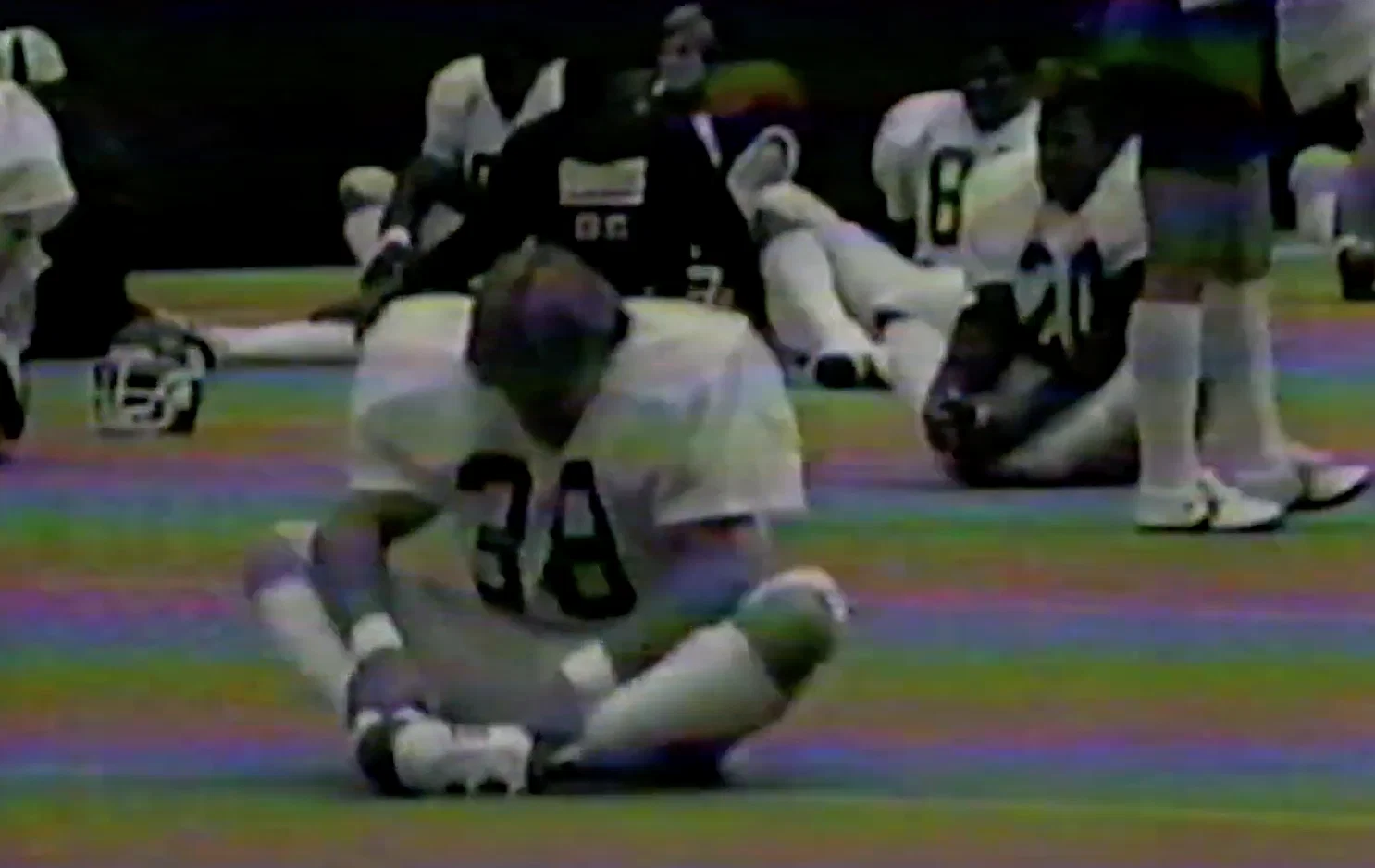 David Corenswet Stars as Real Life NFL Player in ‘Mr. Irrelevant’ Biopic 9 An old clip of John Tuggle, sitting on the ground